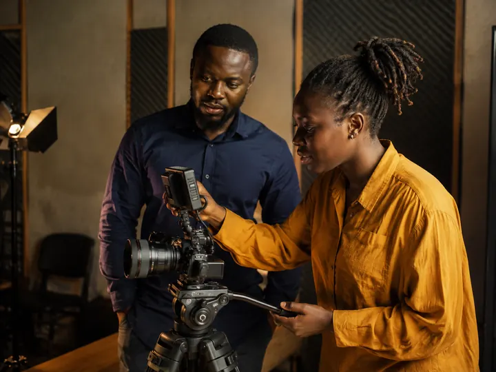 Illustrative Ile-Ife media creators working with a studio camera
