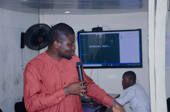 A SkillUp Africa facilitator presenting beside a digital display