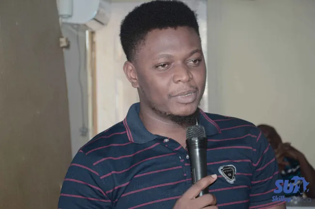 A SkillUp Africa participant speaking into a microphone