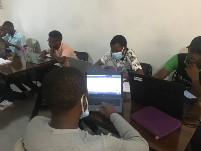 SkillUp Africa participants sharing a laptop during a small-group workshop