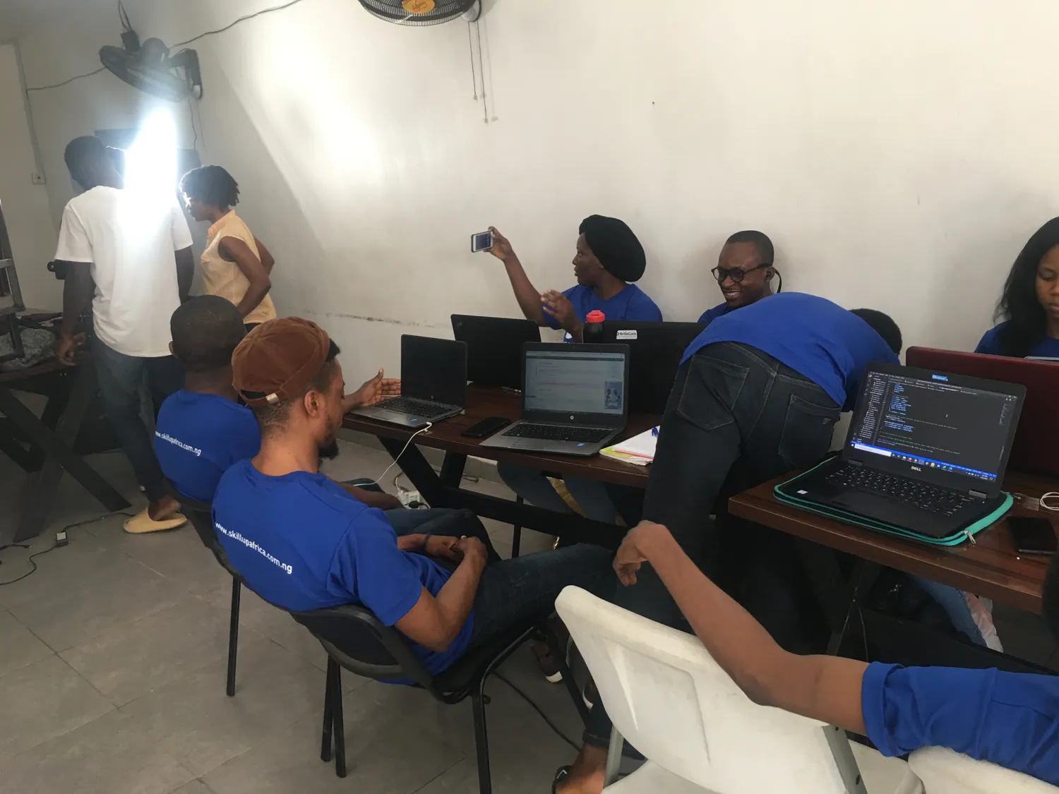 SkillUp Africa participants exchanging ideas during a laptop workshop